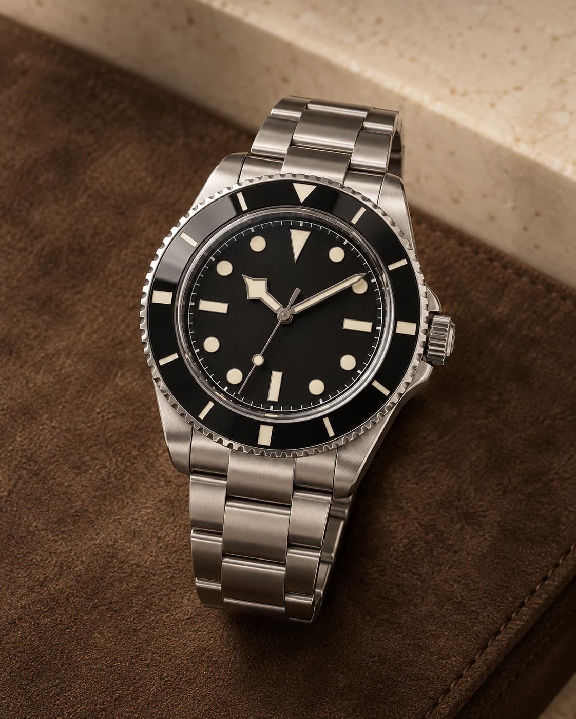 Atlas Diver 42mm in black dial and ceramic bezel on steel, front view on a plain champagne background