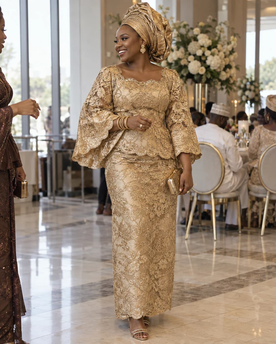 Woman in a gold lace two-piece with a headwrap and stacked gold bangles