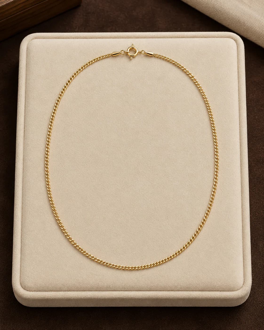 Fine Curb Chain, 9ct in 9ct yellow gold, front view on a plain champagne background