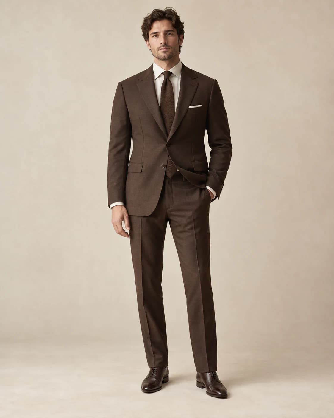 Lucien Two-Piece Suit in chocolate wool, front view on a plain champagne background